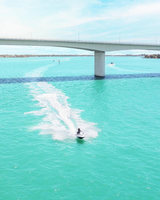 Jet skier under Ringling Bridge in Sarasota Bay