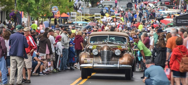 A 1941 Cadillac pulls through the crowd in Fairport, NY.jpg