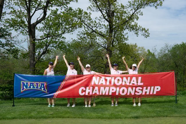 Team Holding Banner with Arms Up.jpg
