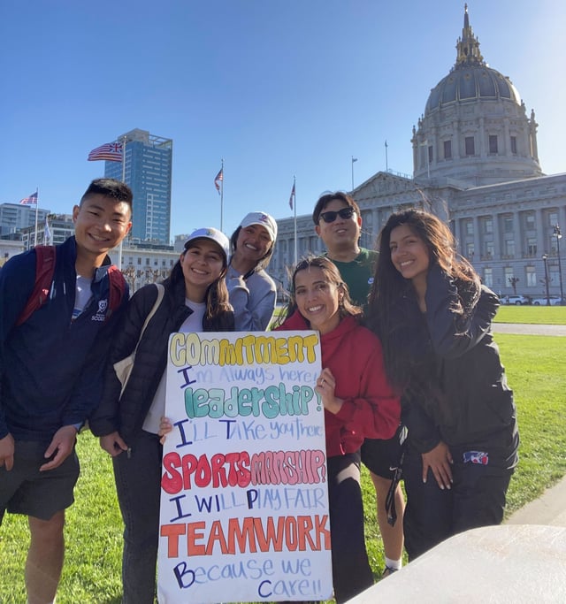 CC game day vol april 2023 with Amber - Rocky and sign.jpg